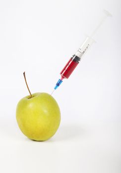 Granny smith apple being injected over white background