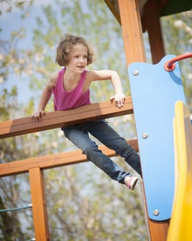Young girl climbing on childrens playground