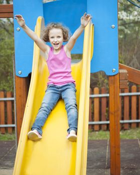 Young girl on slide in playground