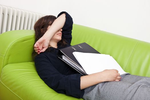 Businesswoman sleeping on a sofa