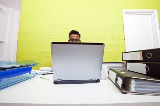 Mans head poking out over top of laptop