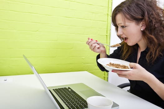 Close up of woman eating at her desk
