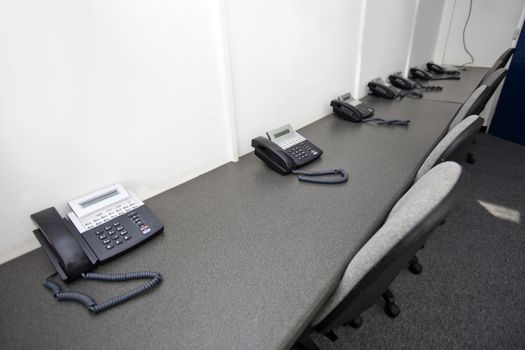 Landline telephones and chairs in television station