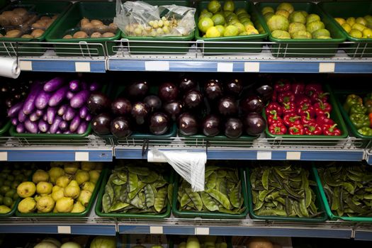 Variety of fruits and vegetables on display in grocery store