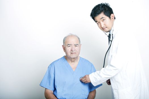 A young Asian Doctor comforting a Senior adult patient