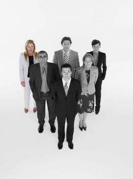 Ambitious businessman with team of professionals against white background
