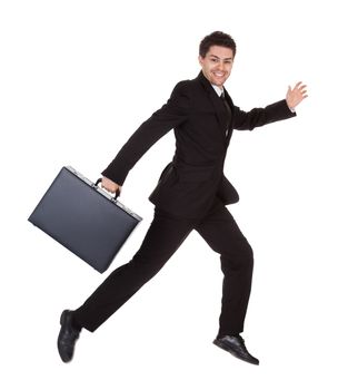 Businessman running with his briefcase