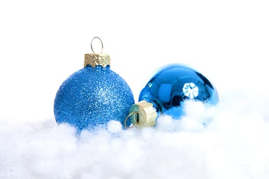 Blue glitter Christmas balls over white background