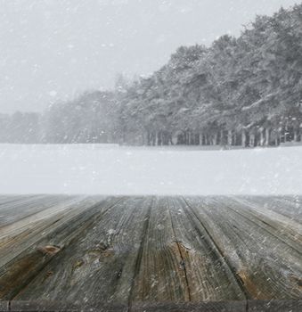 Winter background with wood planks in forefront
