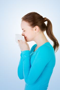Young woman with tissue - sneezing.