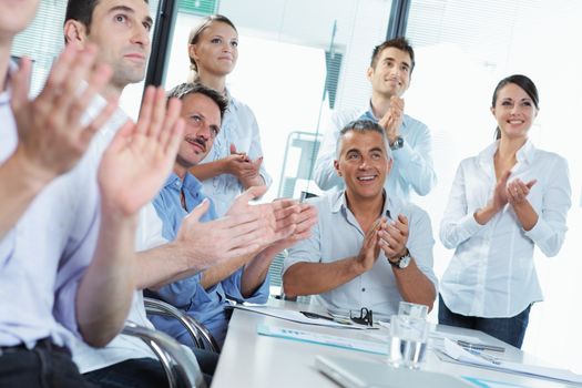 Business people clapping in a meeting