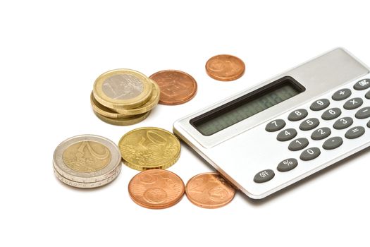 Several euro coins and calculator on white background