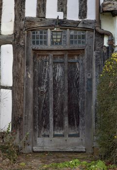 Front entrance doorway to an old Tudor cottage, Warwickshire, England.