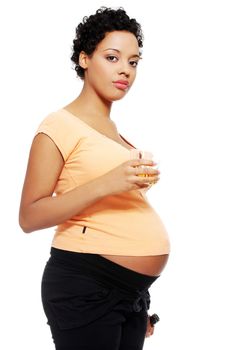 Pregnant woman holding a glass of alcohol next to her tummy