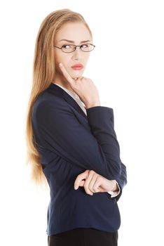 Beautiful business woman in eyeglasses with finger on her cheek is thinking, having an idea. Isolated on white.