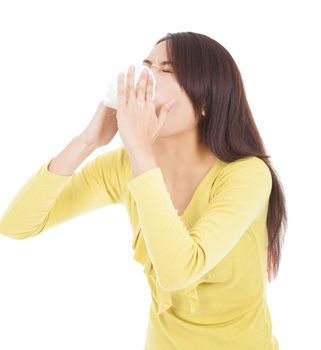 Young woman having flu or allergy and  blowing into tissue