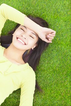 High angle view of a young woman resting on grass