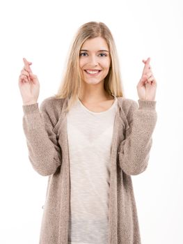 Beautiful blonde woman smiling and cross fingers, isolated over white background