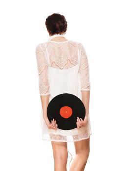 woman holding vinyl record behind her back