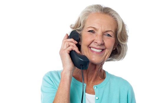 Senior lady holding phone receiver