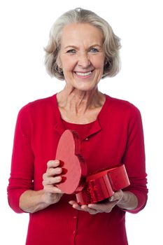 Senior woman with heart shaped gift box