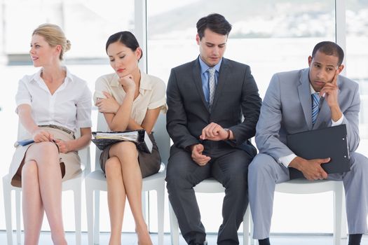 Four business people waiting for job interview