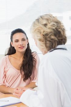Female patient listening to doctor with concentration