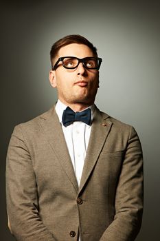 Confident nerd in eyeglasses and bow tie 