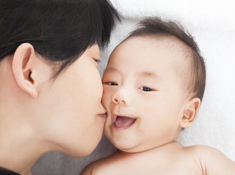 happy asian Mother kiss daughter or son 
