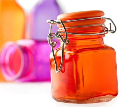 Colorful glass jars on white