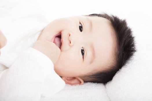 Baby having laughing and lying  on the towel