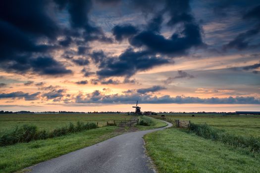 bike path to windmill at sunrise, Holland
