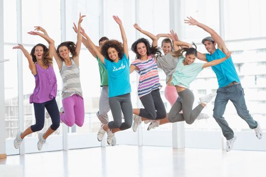 Fitness class jumping in fitness studio