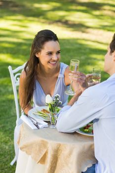 View of a young couple drinking champagne at an outdoor caf├®