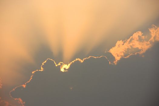 Crepuscular rays behind cloud at sunset