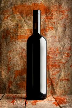 Bottle of red wine on a background of the canvas