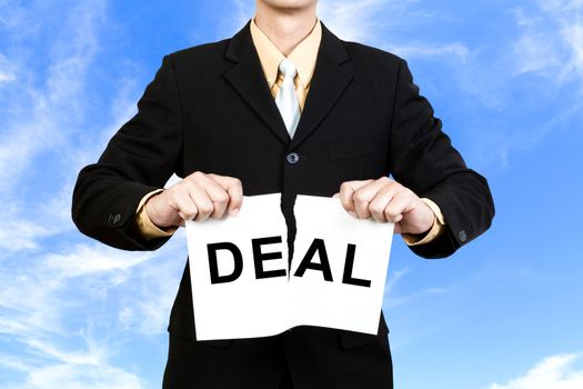 Businessman tear paper with word Deal