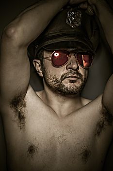 Sexy police, naked man with cap and red mirror glasses