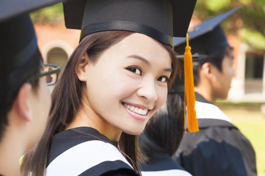 smiling woman standing out from a graduation group