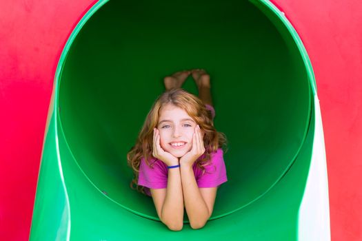 kid girl smiling in the park playground relaxed with hands in face