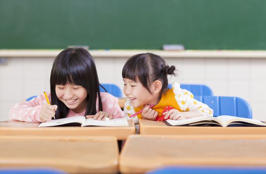 cute little student  look her classmate homework