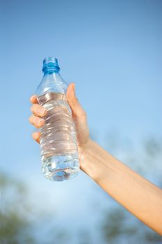 hand holding plasic bottle of water 