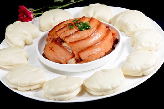 Chinese Food:Steamed Bread with Pork on a black background