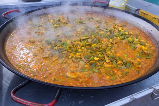 Cooking paella typical from Valencia Spain recipe with rice