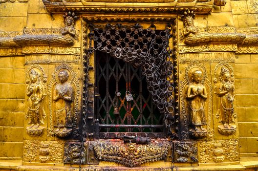 Detail of golden statues in buddhist and hindu temple, Kathmandu