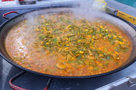 Cooking paella typical from Valencia Spain recipe with rice
