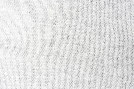 Light gray knitwork. Light gray wool knitwork full frame for warming backdrop or background.