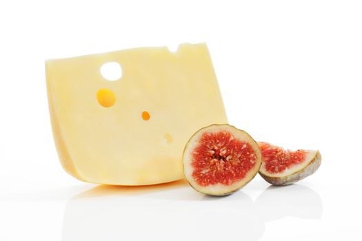 Emmental piece with fig on white.