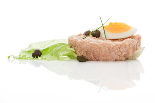 Tuna with eggs and salad isolated on white background.