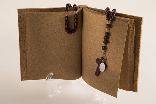 Holy Rosary necklace on cork book
